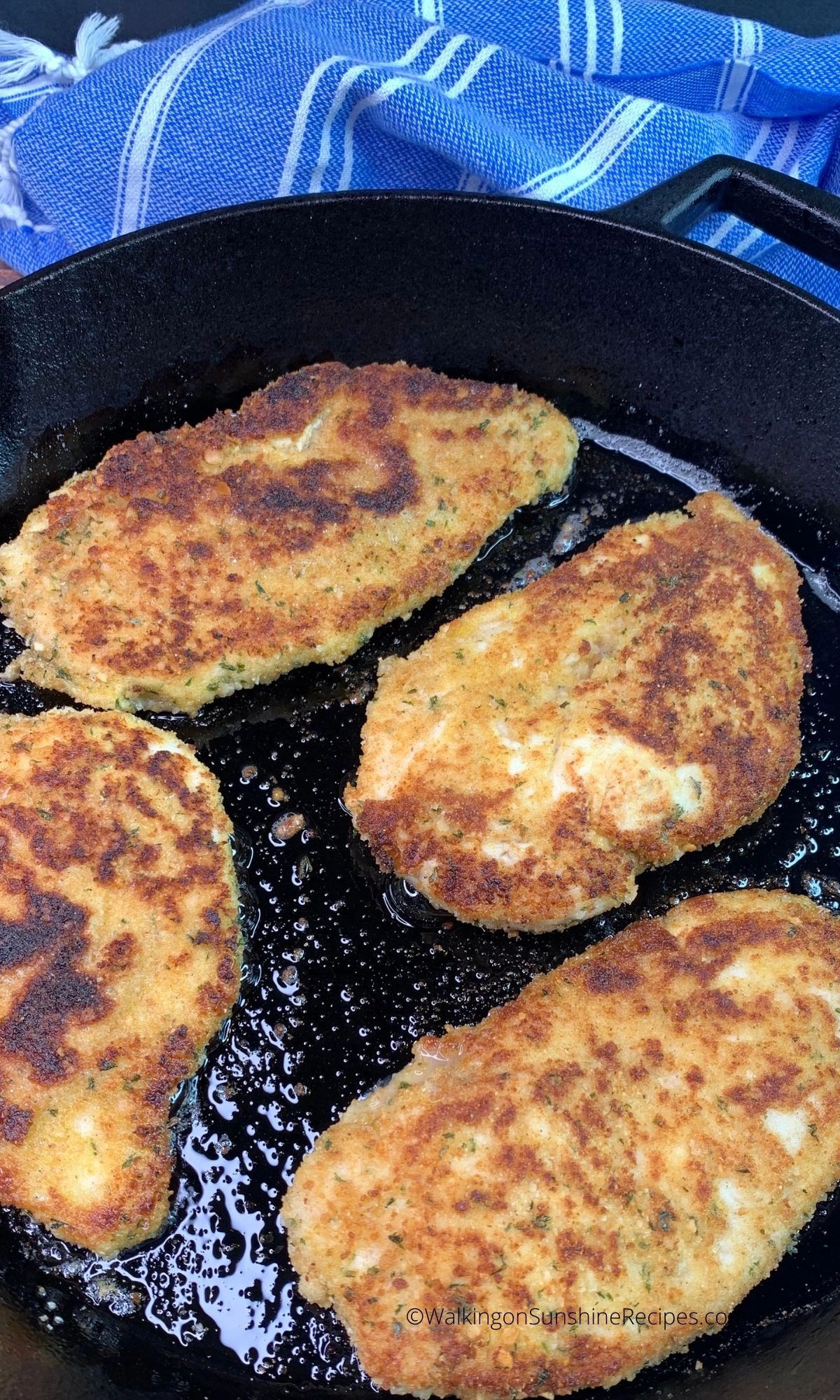 Chicken cutlets in cast iron skillet cooked. 