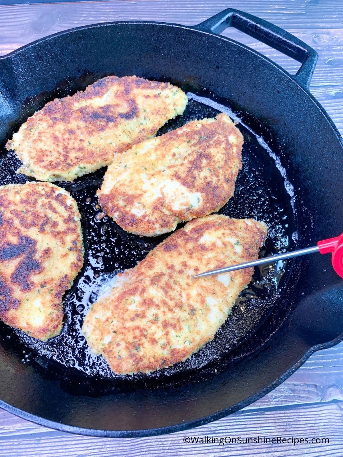 Cooked Perdue chicken cutlets in cast iron skillet.