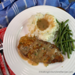 chicken with gravy on white plate.