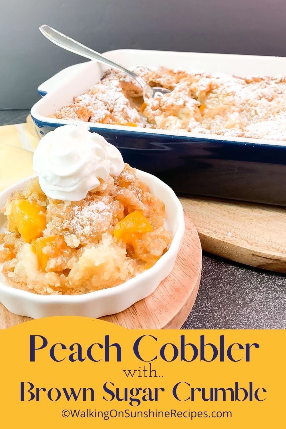Peach cobbler in small bowl with whipped cream on top. 