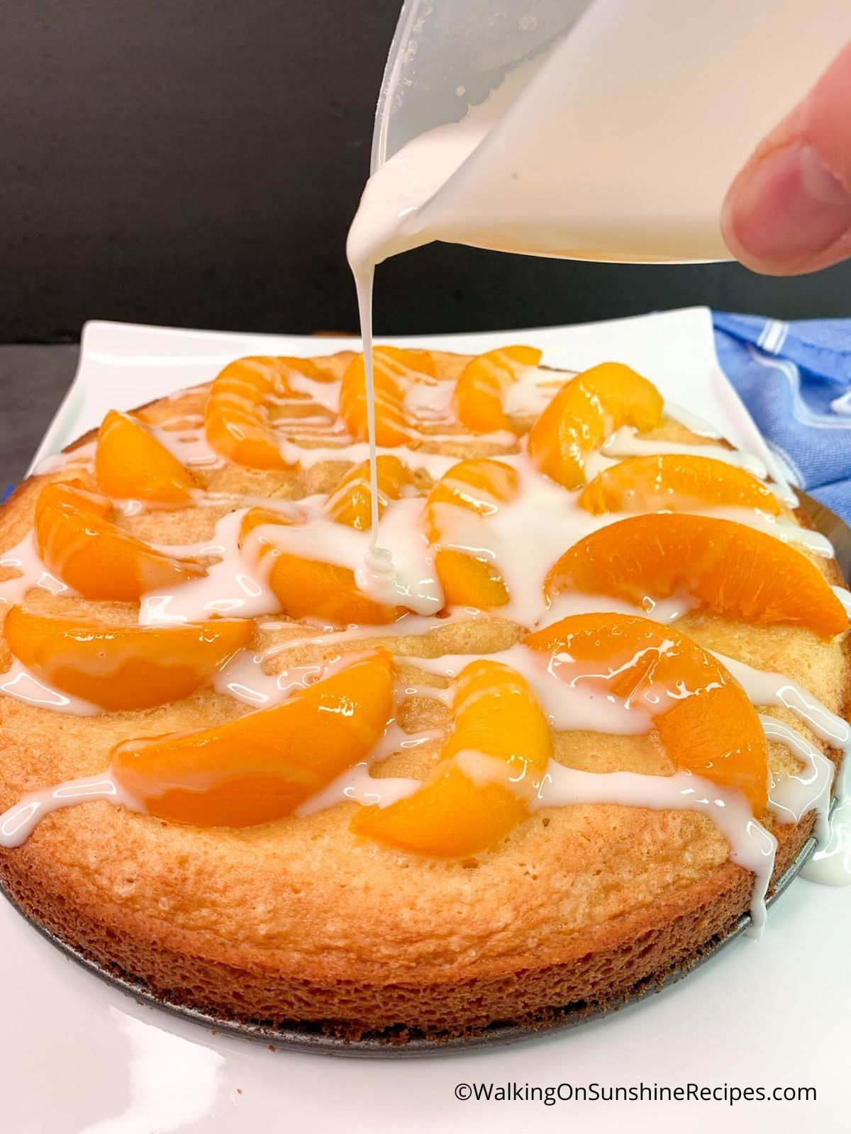 Pour glaze on top of baked peach cake.