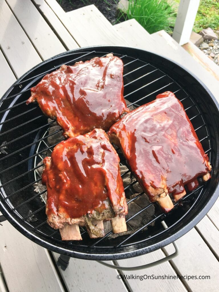 BBQ Ribs with barbecue sauce on charcoal grill.