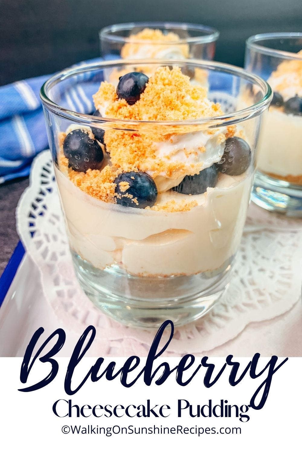 cheesecake pudding in cup with blueberries on top.
