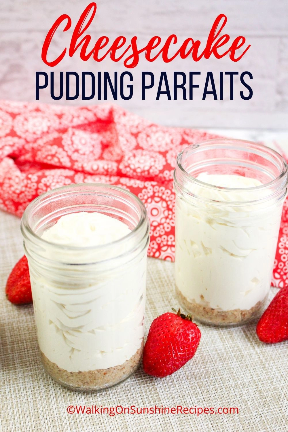 cheesecake pudding served in mason jars with strawberries on the side. 