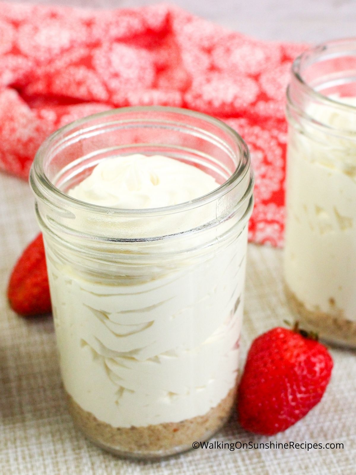 Cheesecake Pudding in mason jar with graham cracker crumb on bottom.
