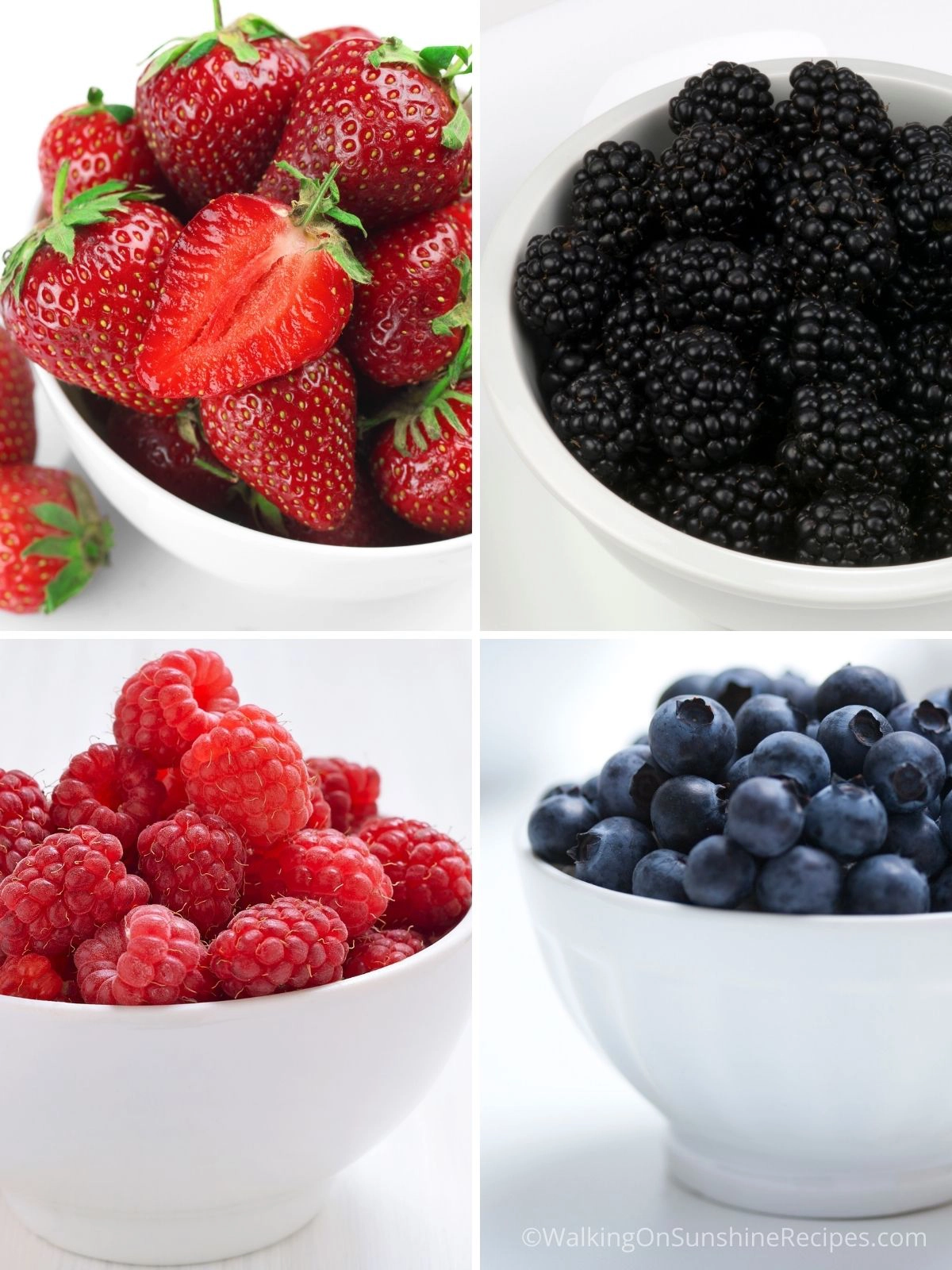 Strawberries, blackberries, raspberries and blueberries in white bowls. 