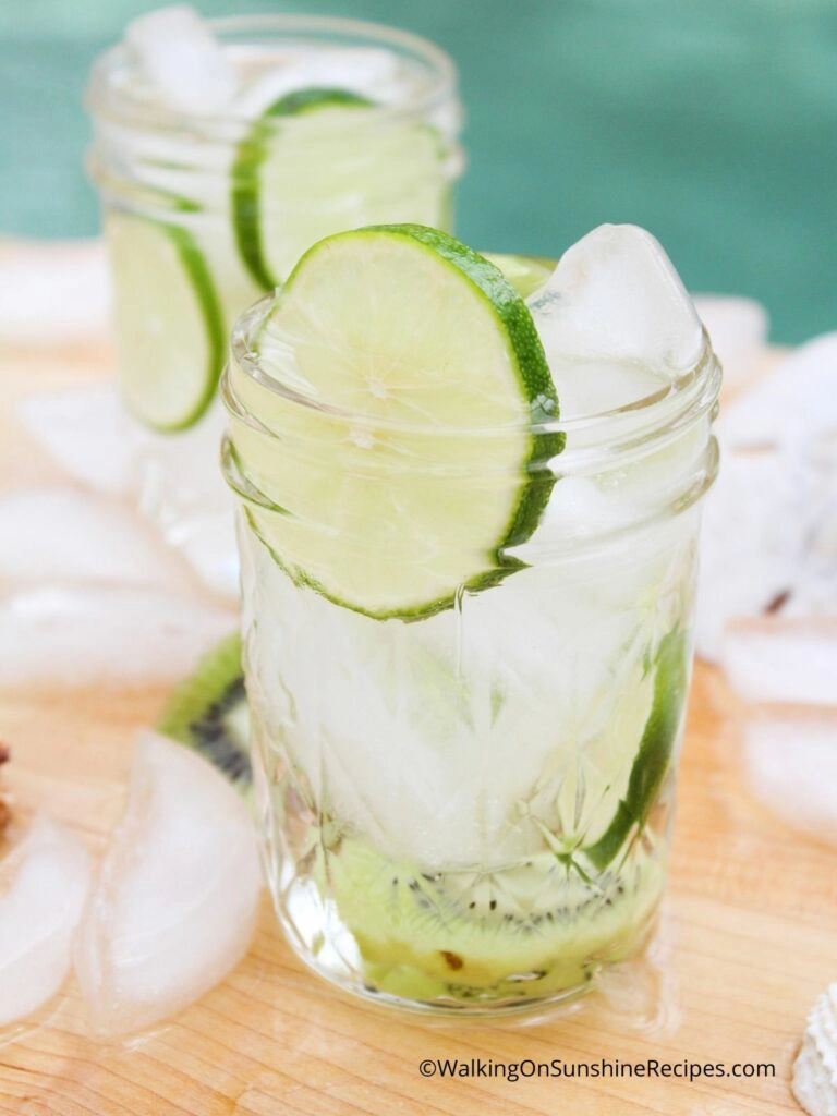 ice in mason jars with water and fresh lime slices. 