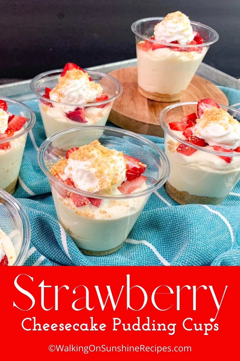 Small cups filled with pudding and fresh strawberries. 
