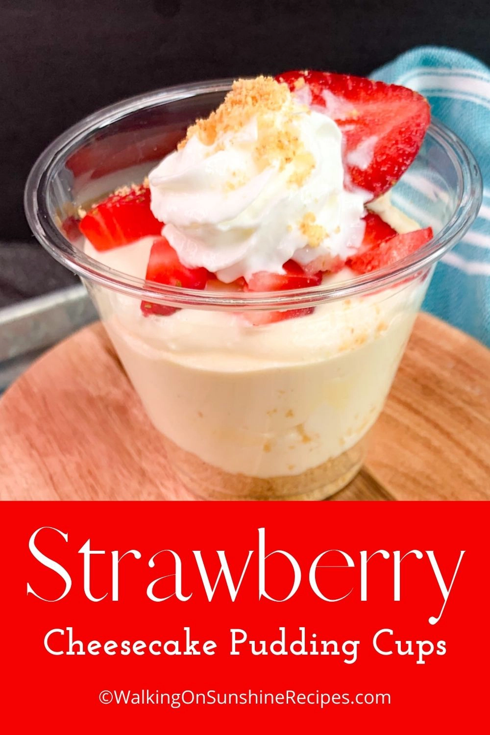 Cheesecake pudding cup topped with strawberries and whipped cream. 