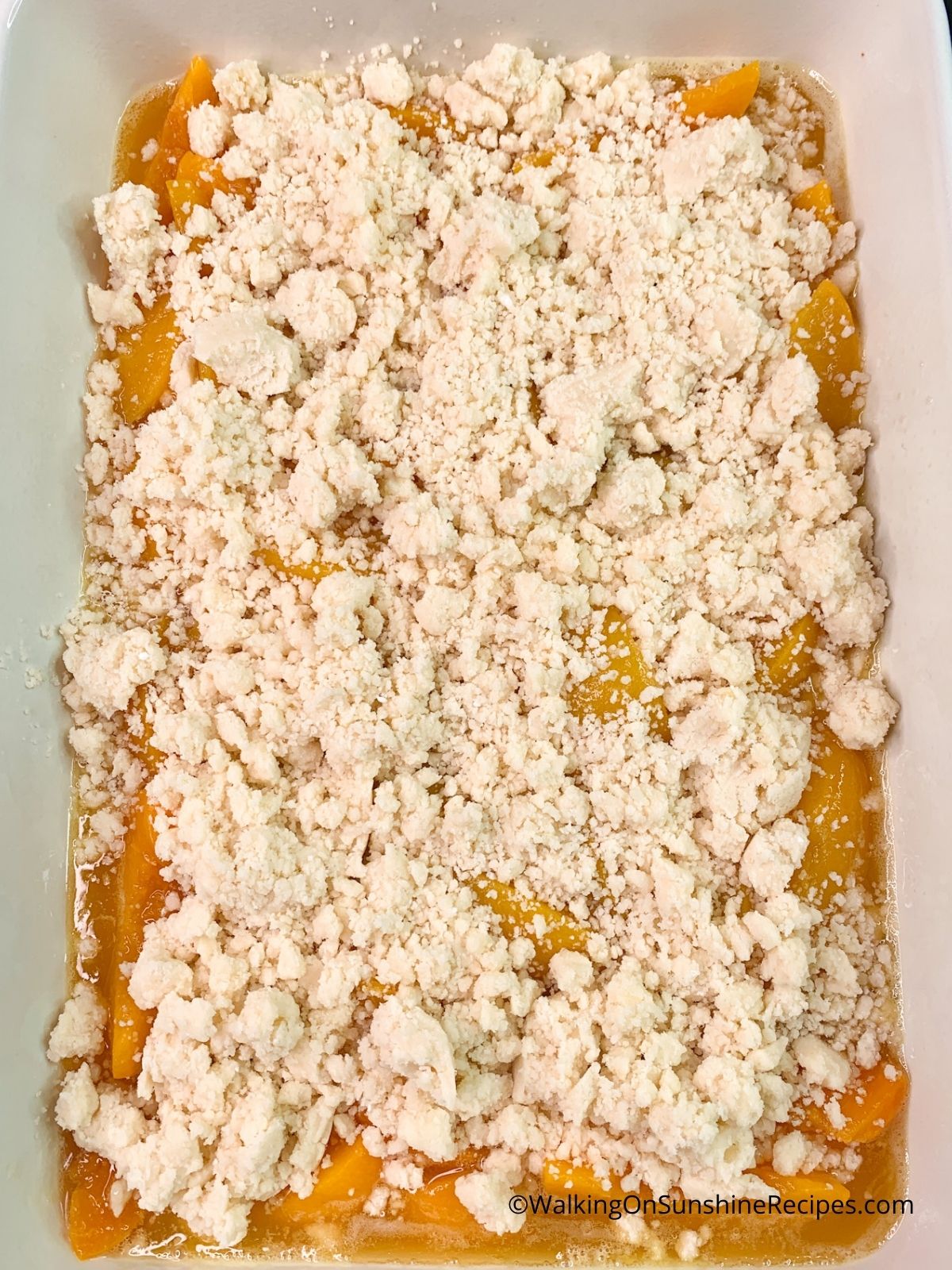 white cake mix on top of canned peaches.