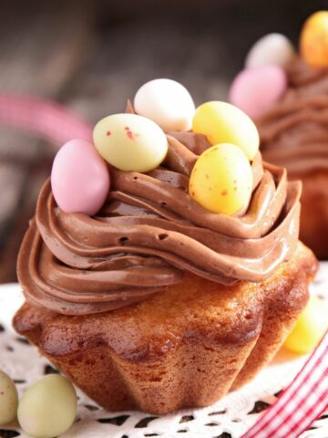 mini bundt cakes with chocolate frosting and candy eggs for Easter desserts.