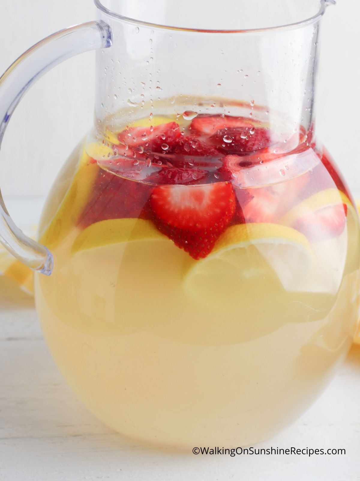 Fresh lemons and strawberries in Lemonade.