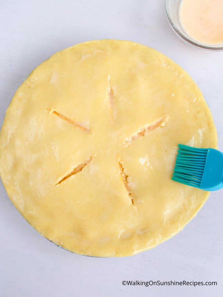 brush top of peach pie with egg wash and sugar