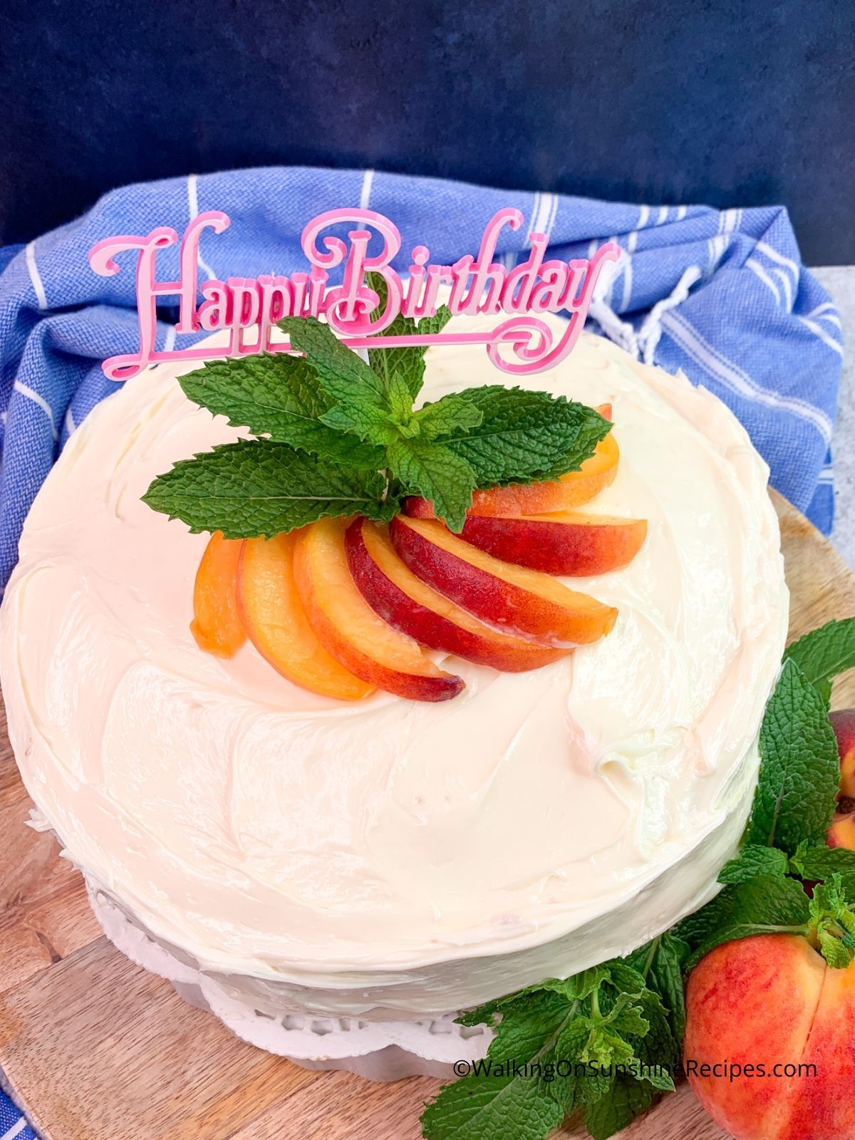 peach birthday cake with fresh peaches.