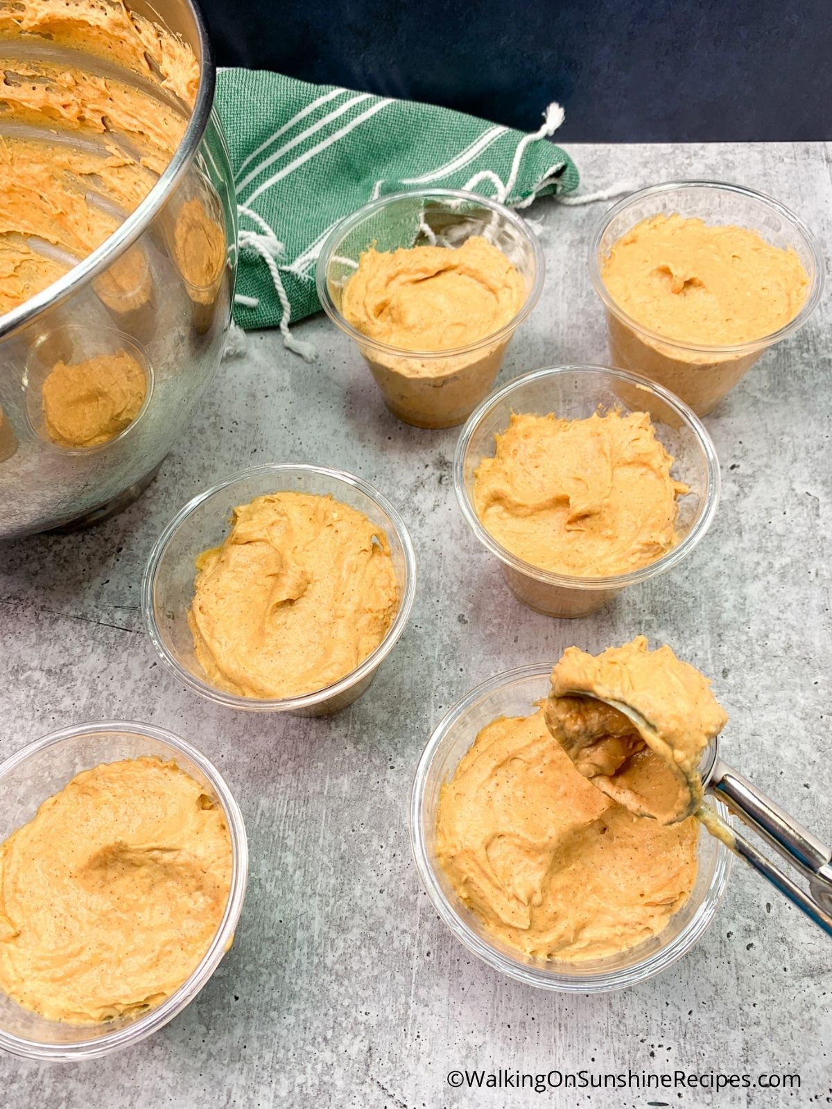 Add Pumpkin Cheesecake to cups with cookie scoop.