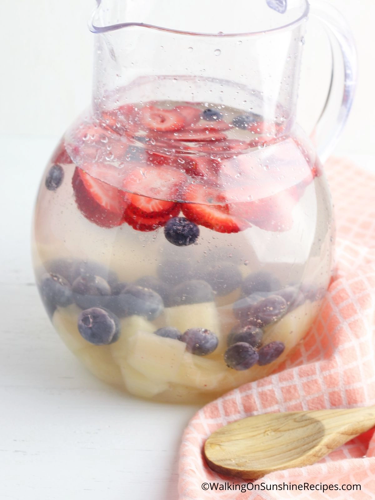 Coconut water, fruit in pitcher.