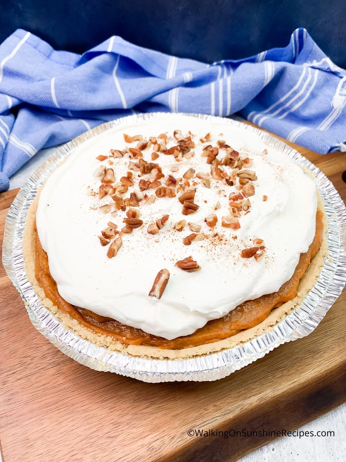 pumpkin cheesecake with chopped pecans on top. 