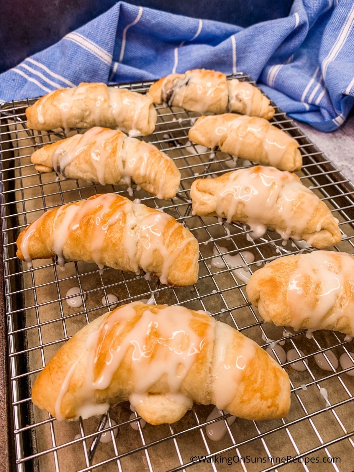 Crescents baked and with powdered sugar glaze.