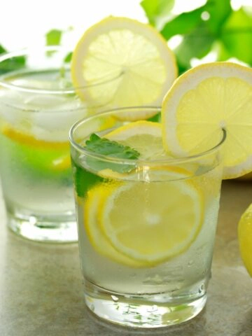 glasses of water with lemon slices.