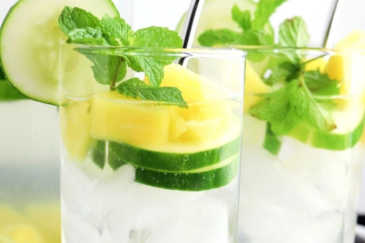 Chunks of pineapple floating in chilled water.
