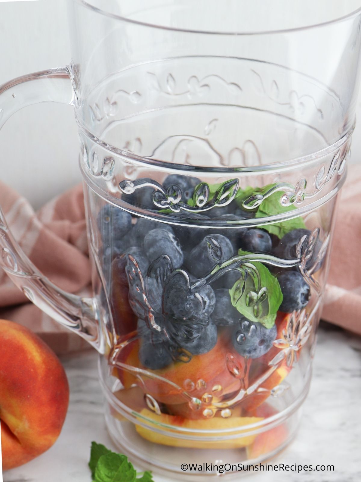 Place blueberries and peaches in pitcher.