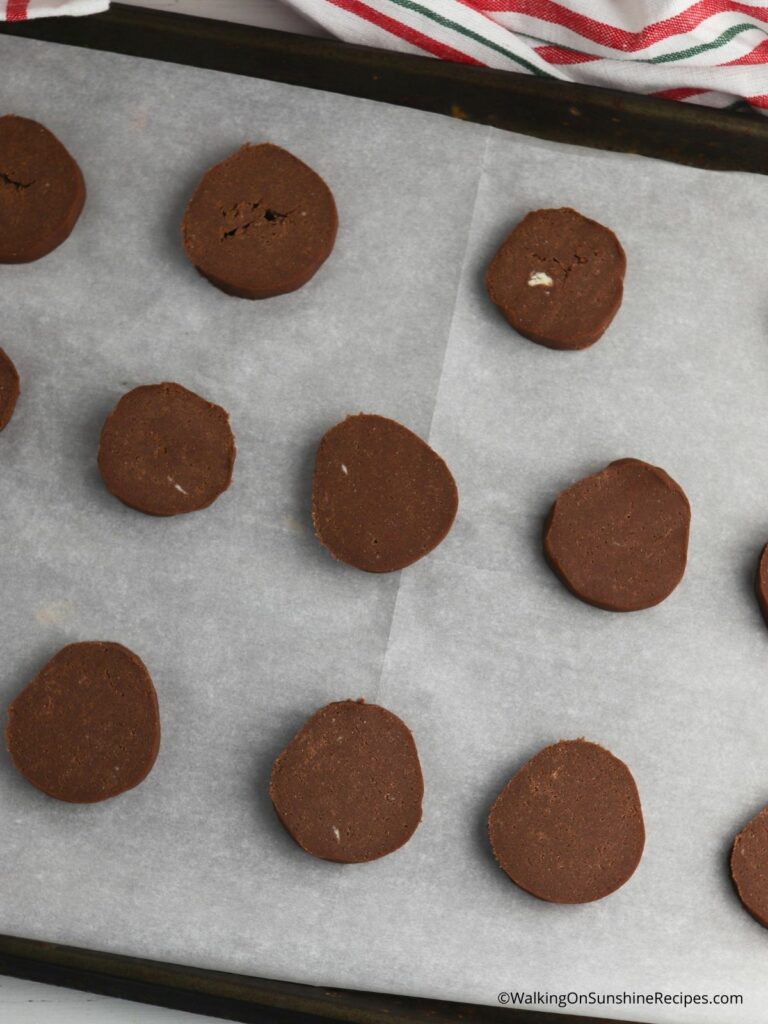 sliced and bake chocolate cookies on baking tray. 
