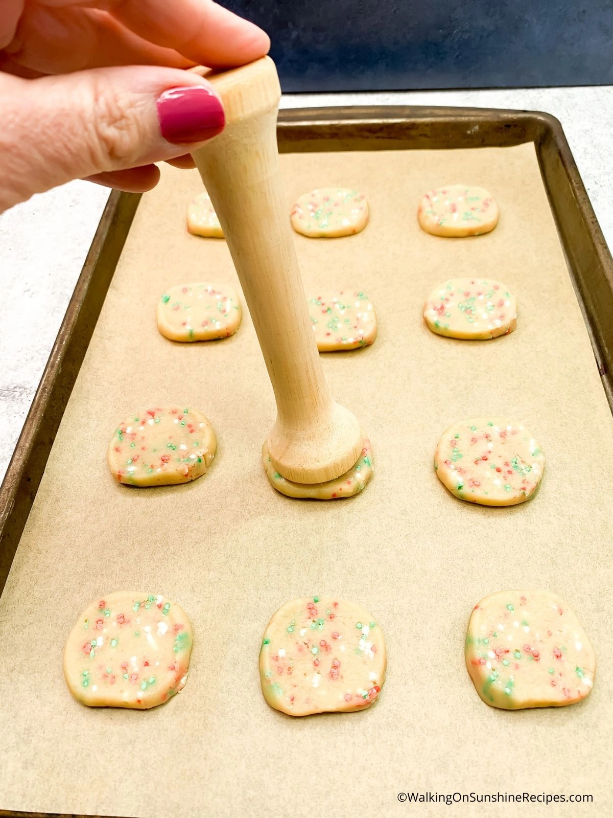 Press out cookie dough using tart tamper.