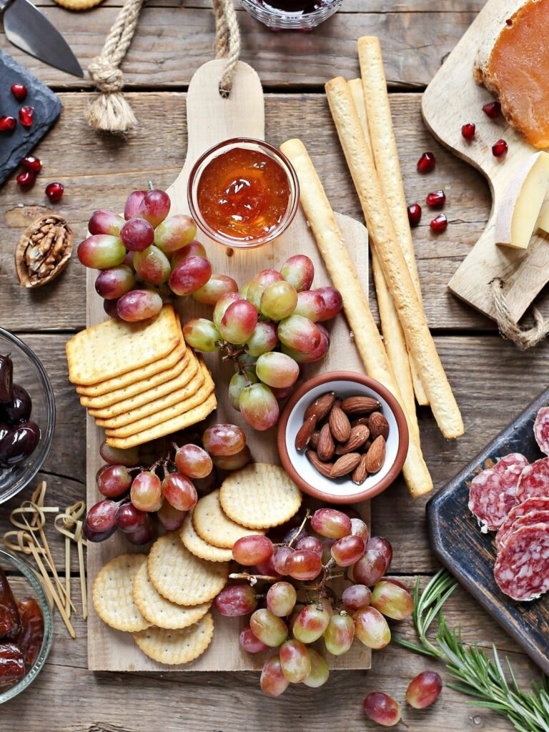 cheese board, fruit, nuts and jam. 