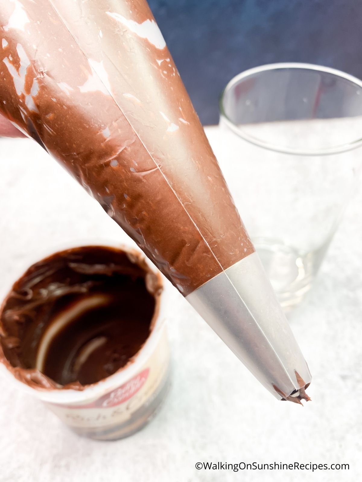 Add chocolate frosting to decorating bag.