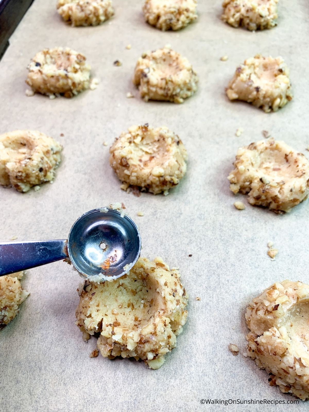 Add indentation to cookie balls with melon scoop.