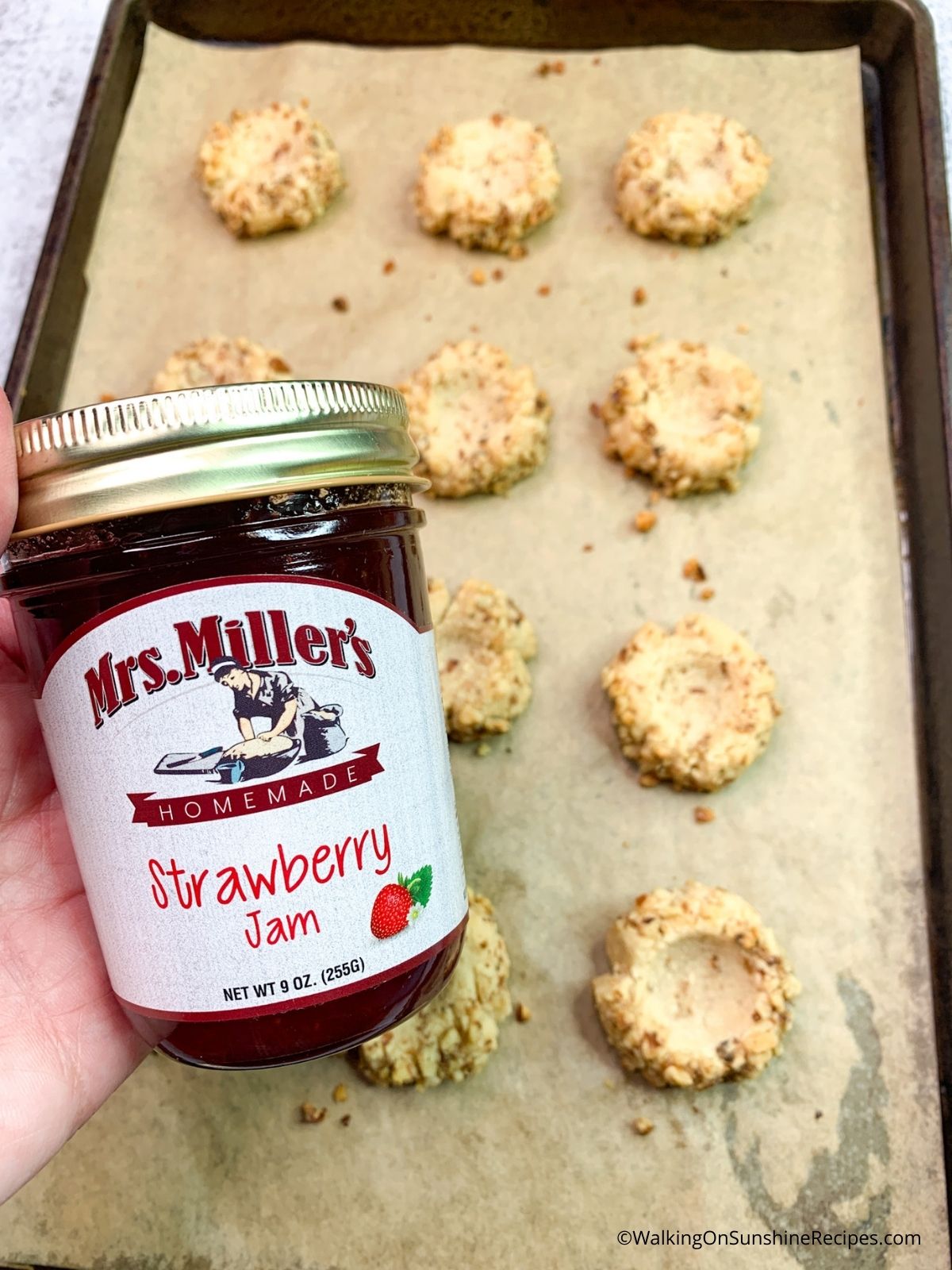 Add jam to baked cookies.