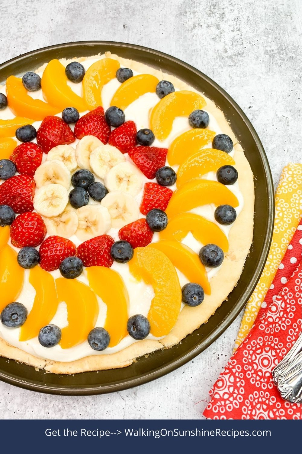 Crescent Roll Fruit Pizza with bananas, peaches, strawberries and blueberries. 