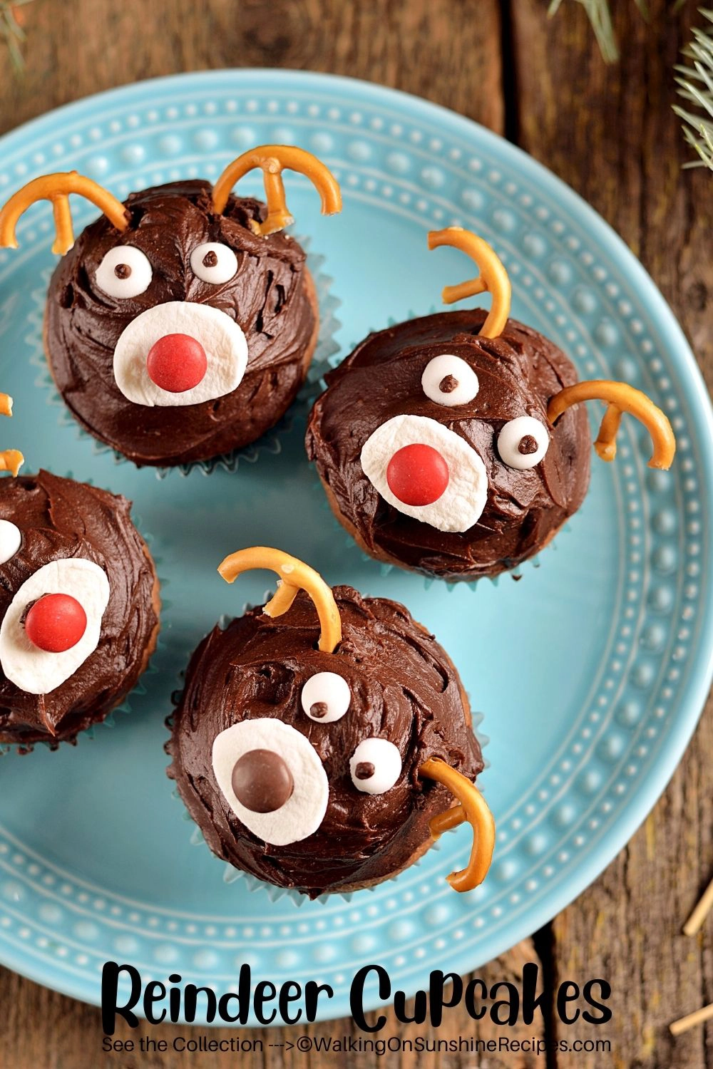 cupcakes decorated as reindeers on blue plate. 