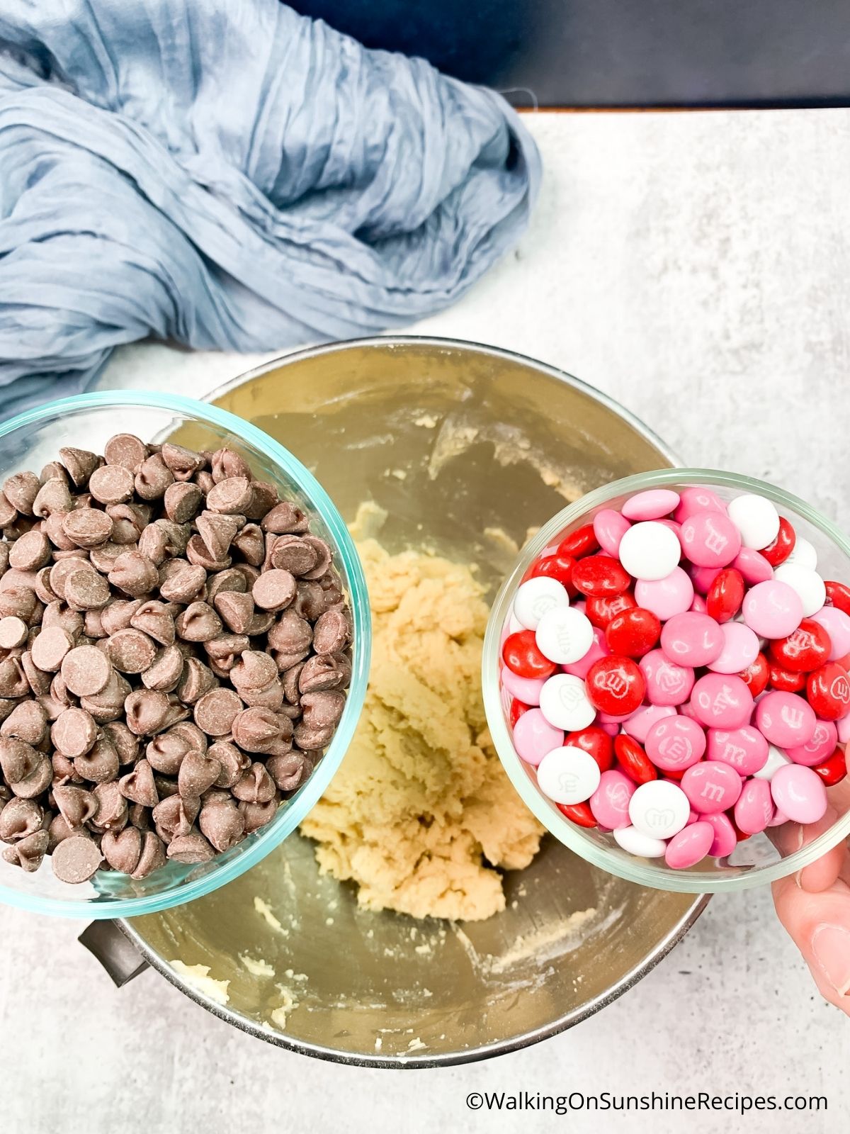 Add chocolate chips and M&M Candy pieces to raw dough.