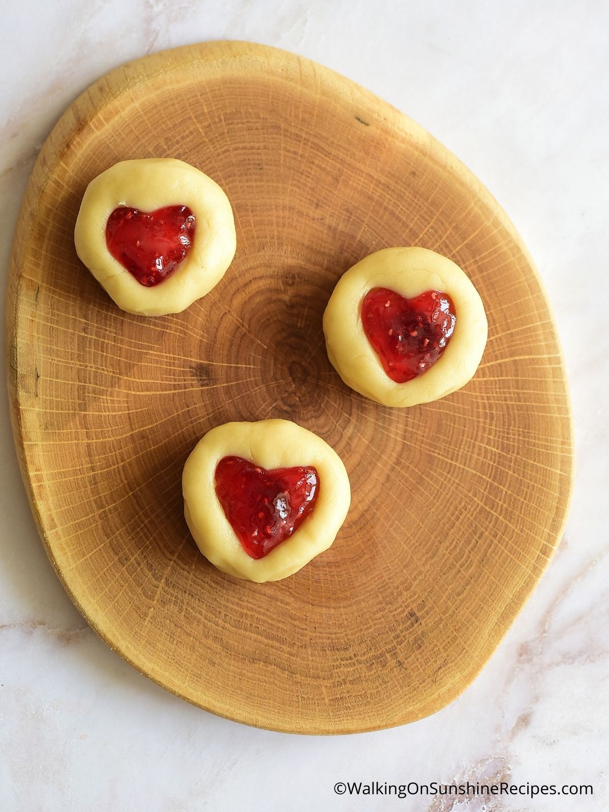 Fill thumbprints with jam.