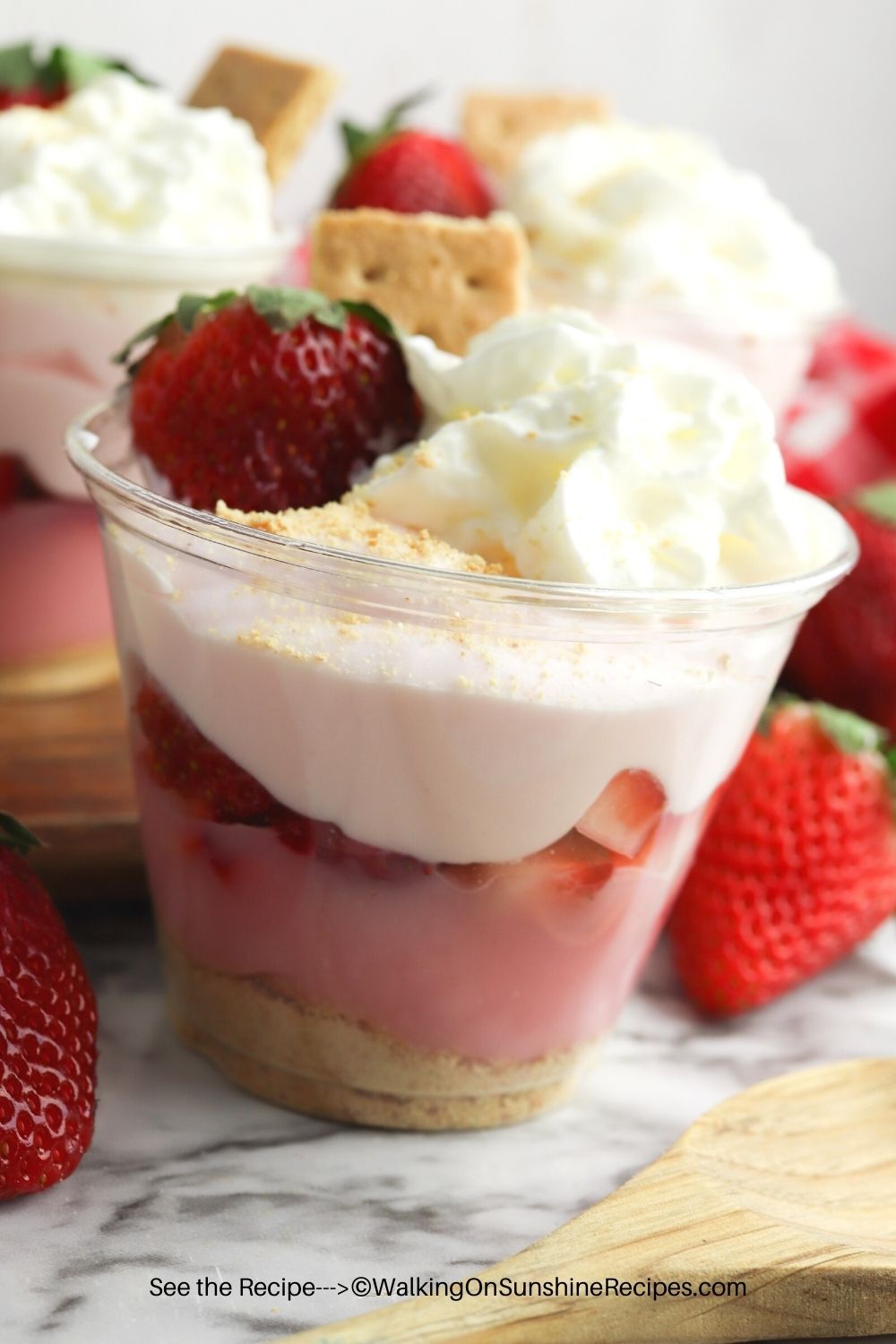 Closeup of strawberry pudding cups with fresh strawberrries. 