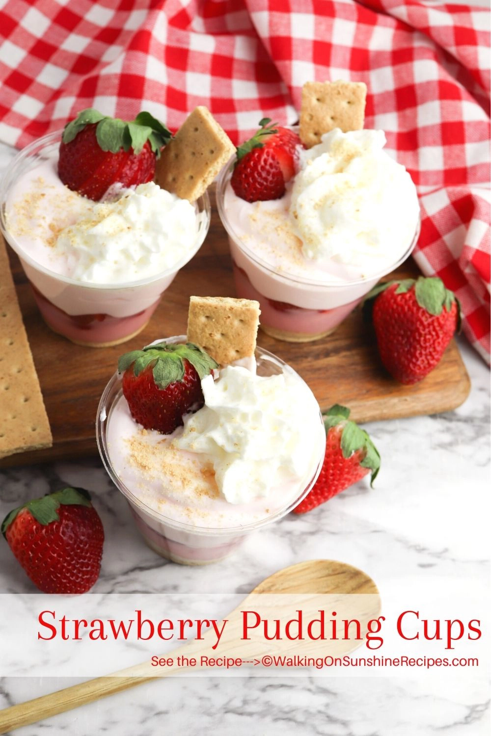 strawberry pudding cups with whipped topping, fresh strawberries and graham crackers. 