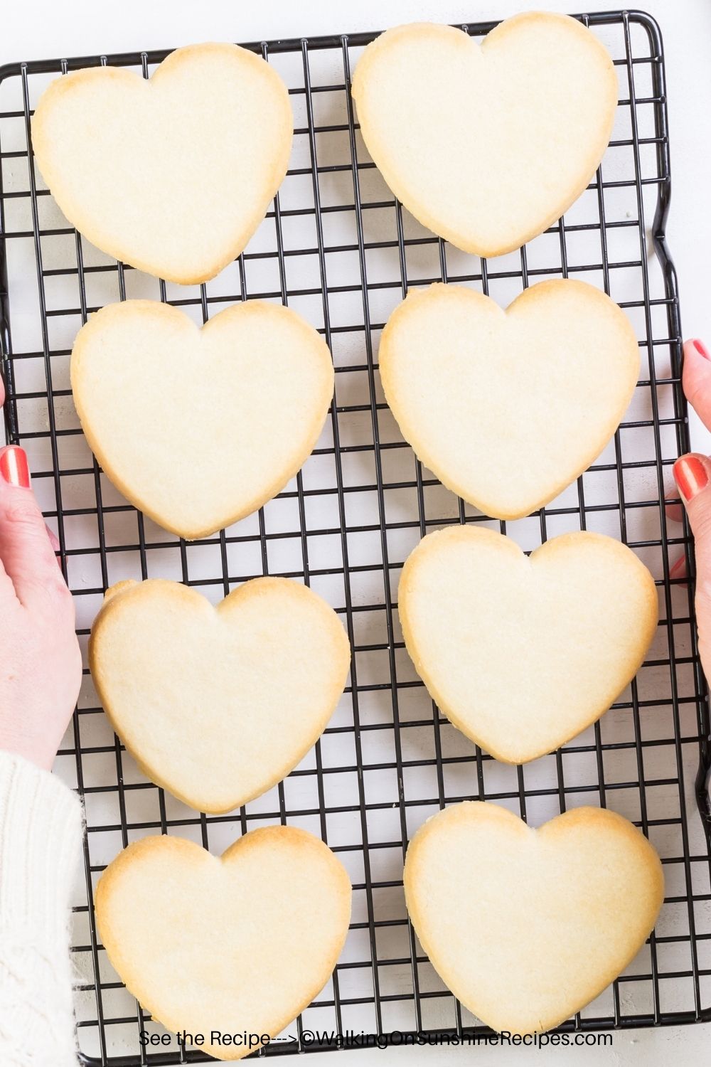 heart shaped sugar cookies on a cooling rack. 