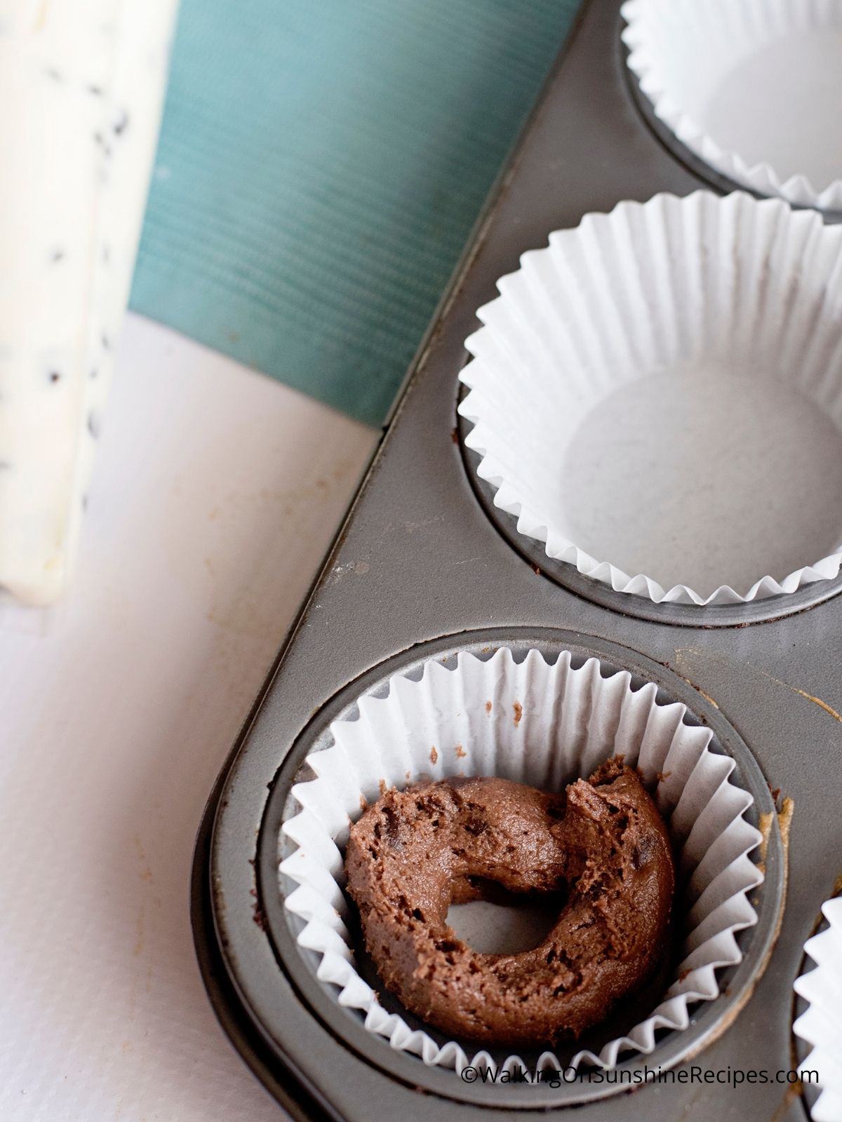 Add chocolate batter to muffin tin.