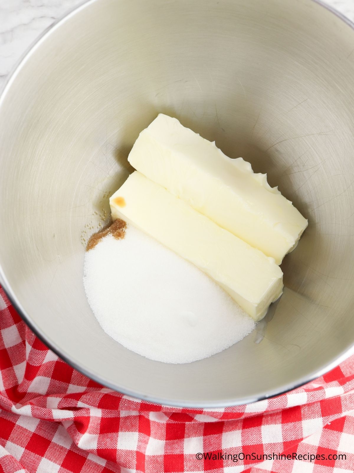 Combine butter with sugar in KitchenAid Mixer.