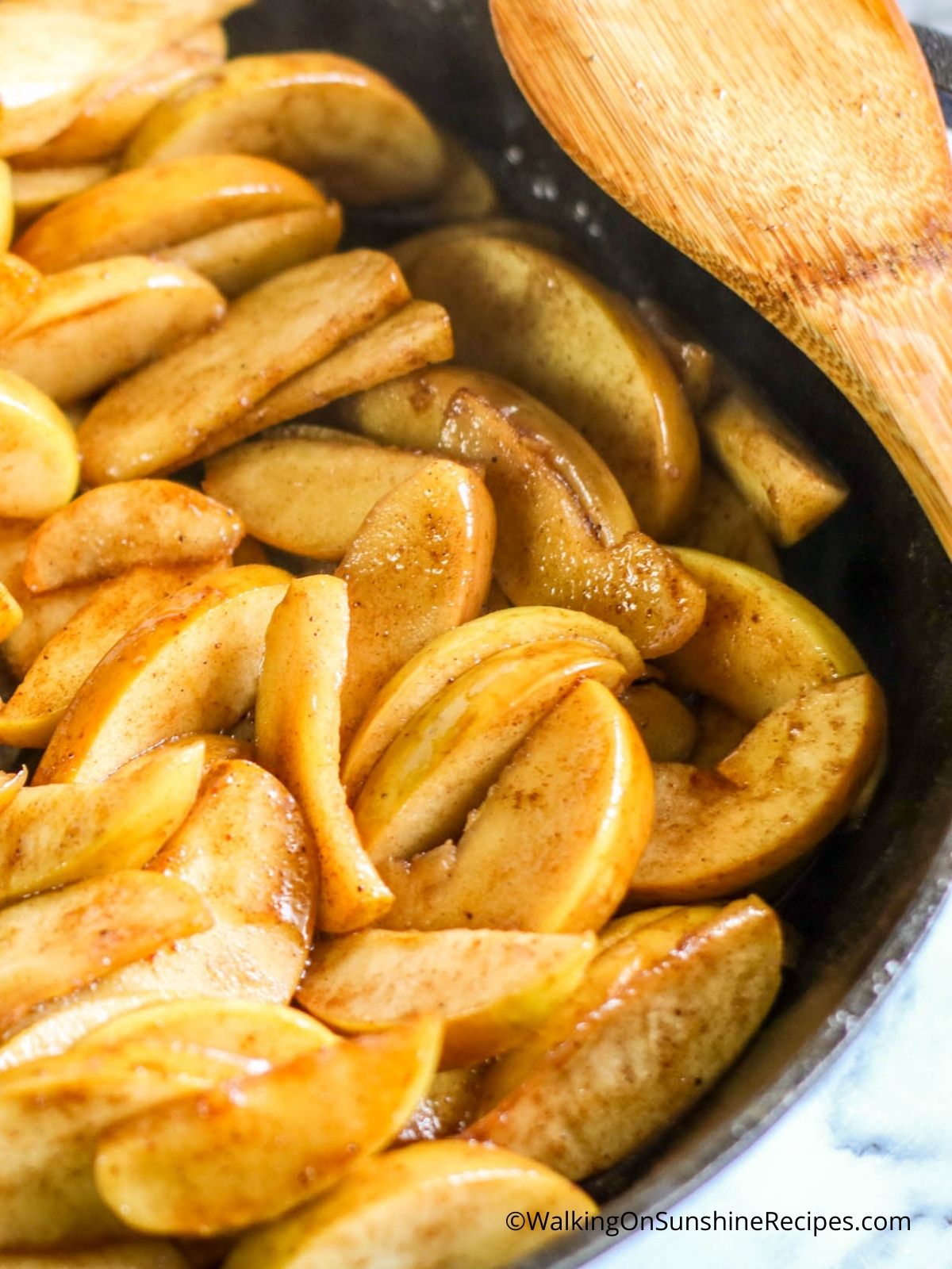 Cook apples in cast iron pan till soft and tender.