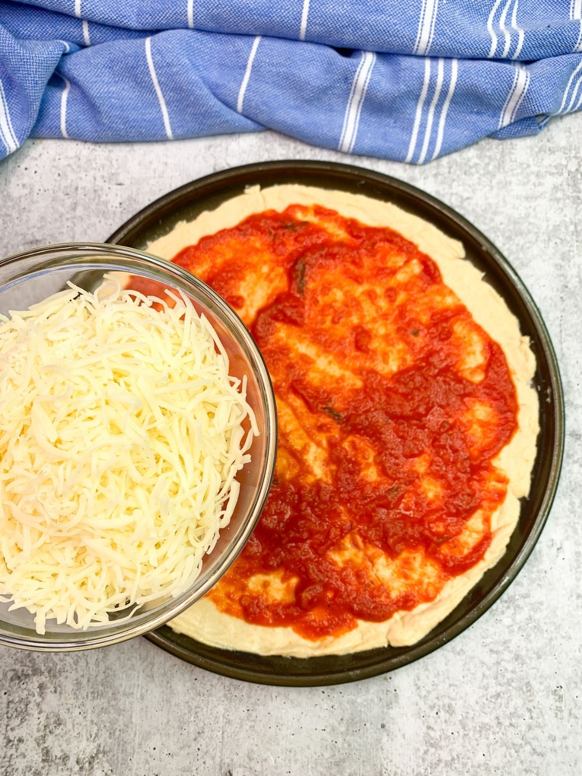 Mozzarella cheese for crescent roll pizza with tomato sauce.