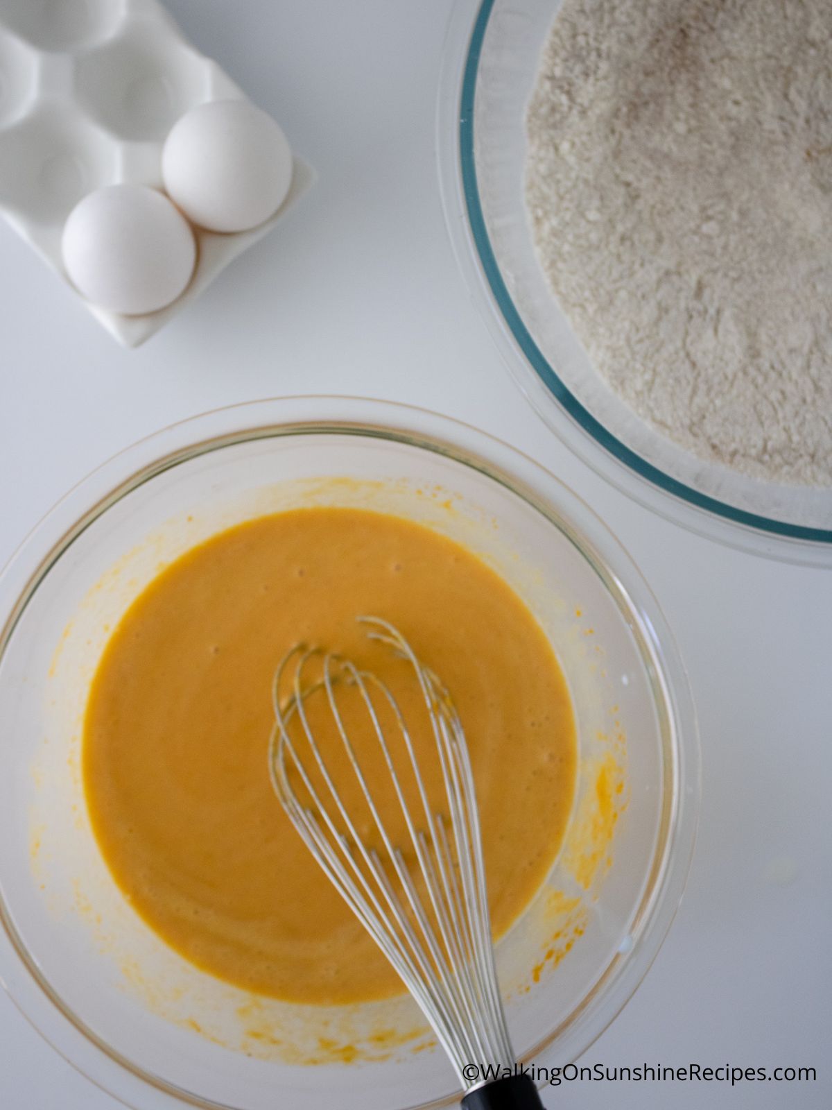 Eggs, bowl of dry ingredients, and bowl of pumpkin mixture