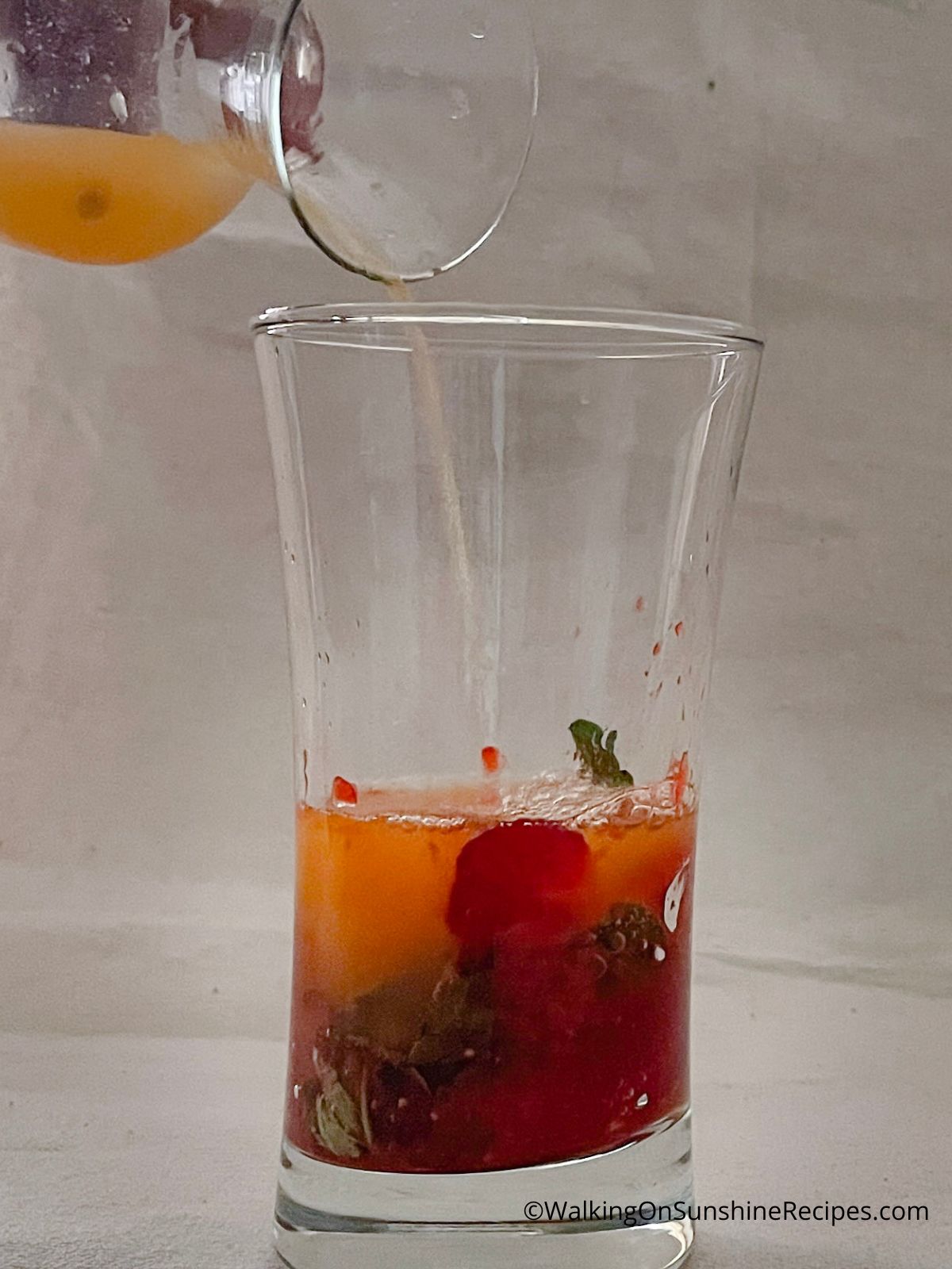 Add the seltzer water to the crush fruit and fresh mint.