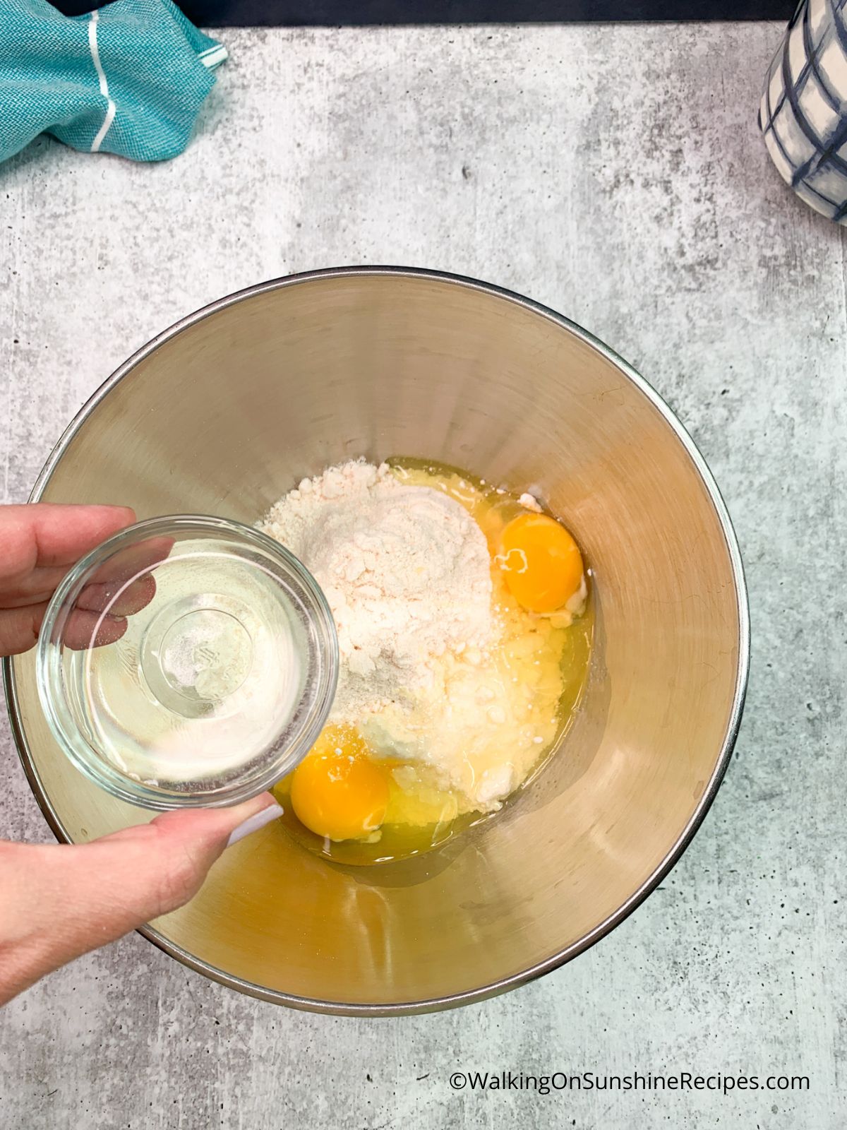 small bowl of water over cake mix with eggs.