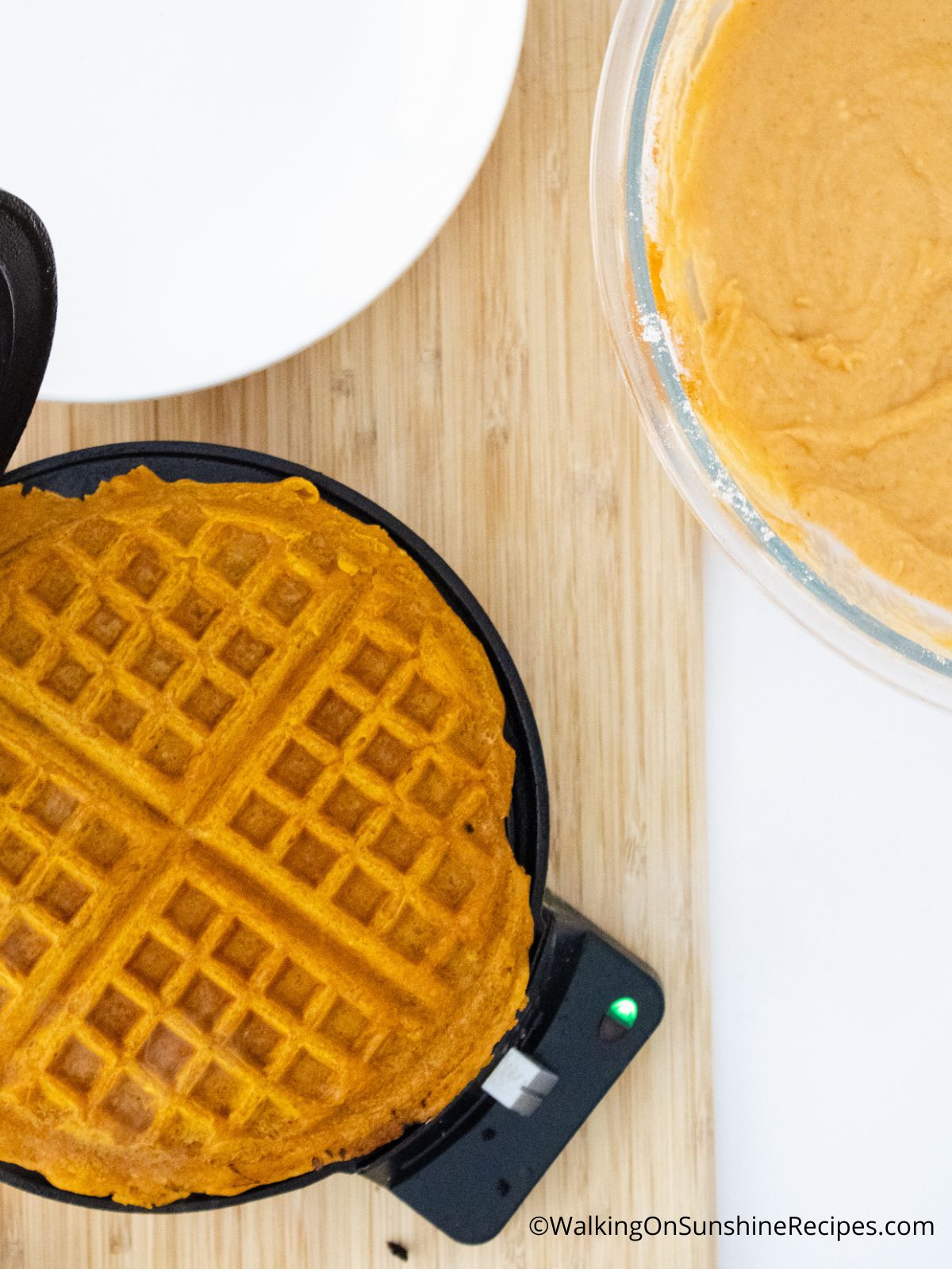 Baked waffle in an opened waffle maker