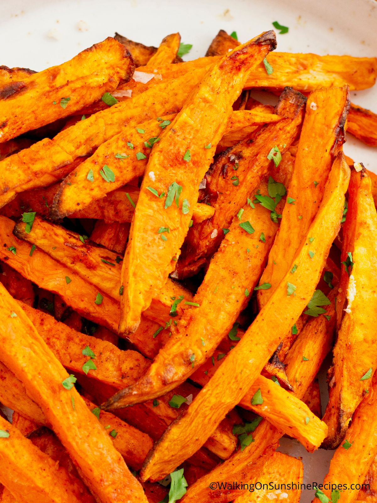 baked crispy sweet potatoes with chopped parsley.