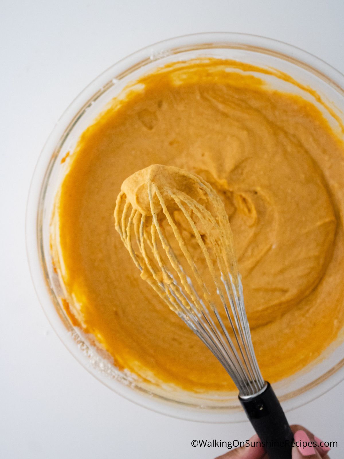 Pumpkin Waffles batter in a mixing bowl with a whisk
