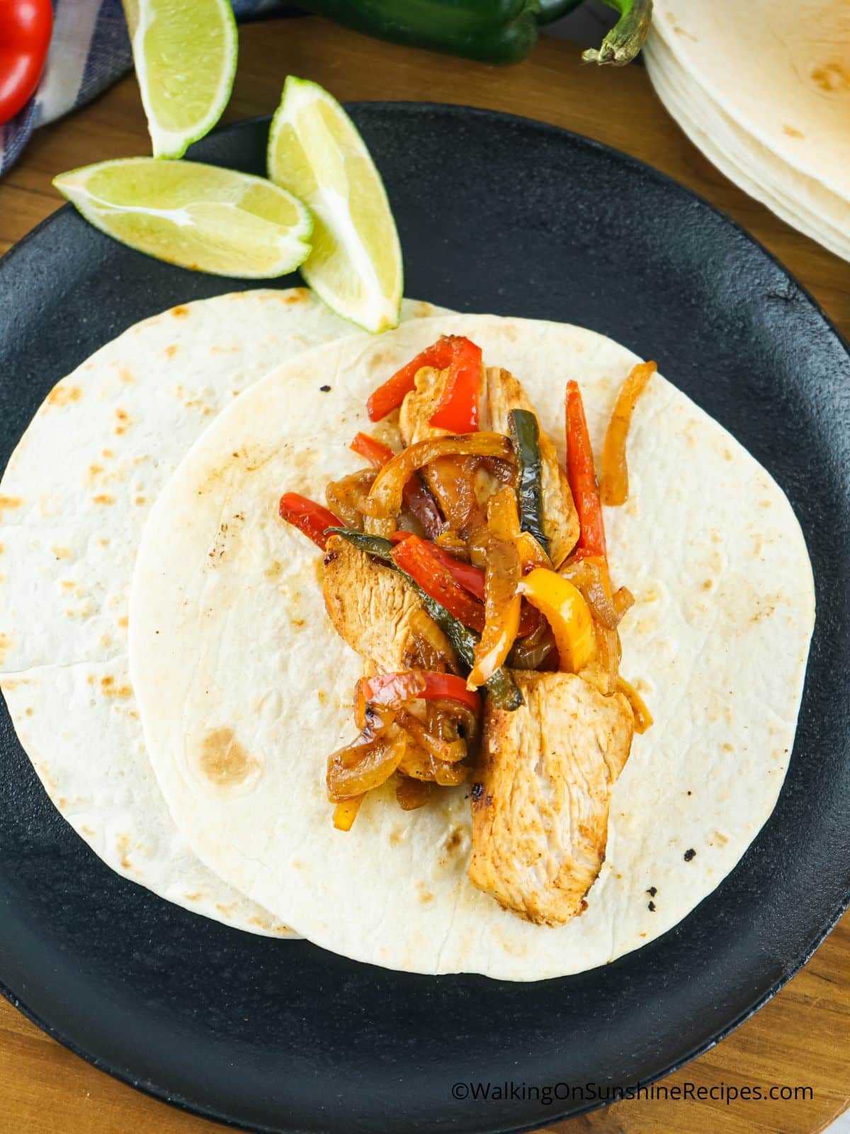 chicken with flour tortilla and peppers and onions.
