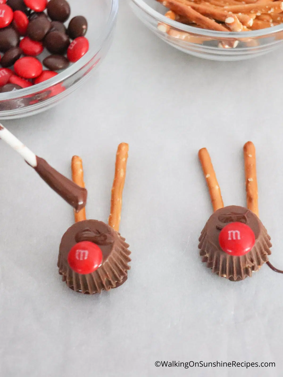 Add red M&Ms for reindeer nose to peanut butter cups.